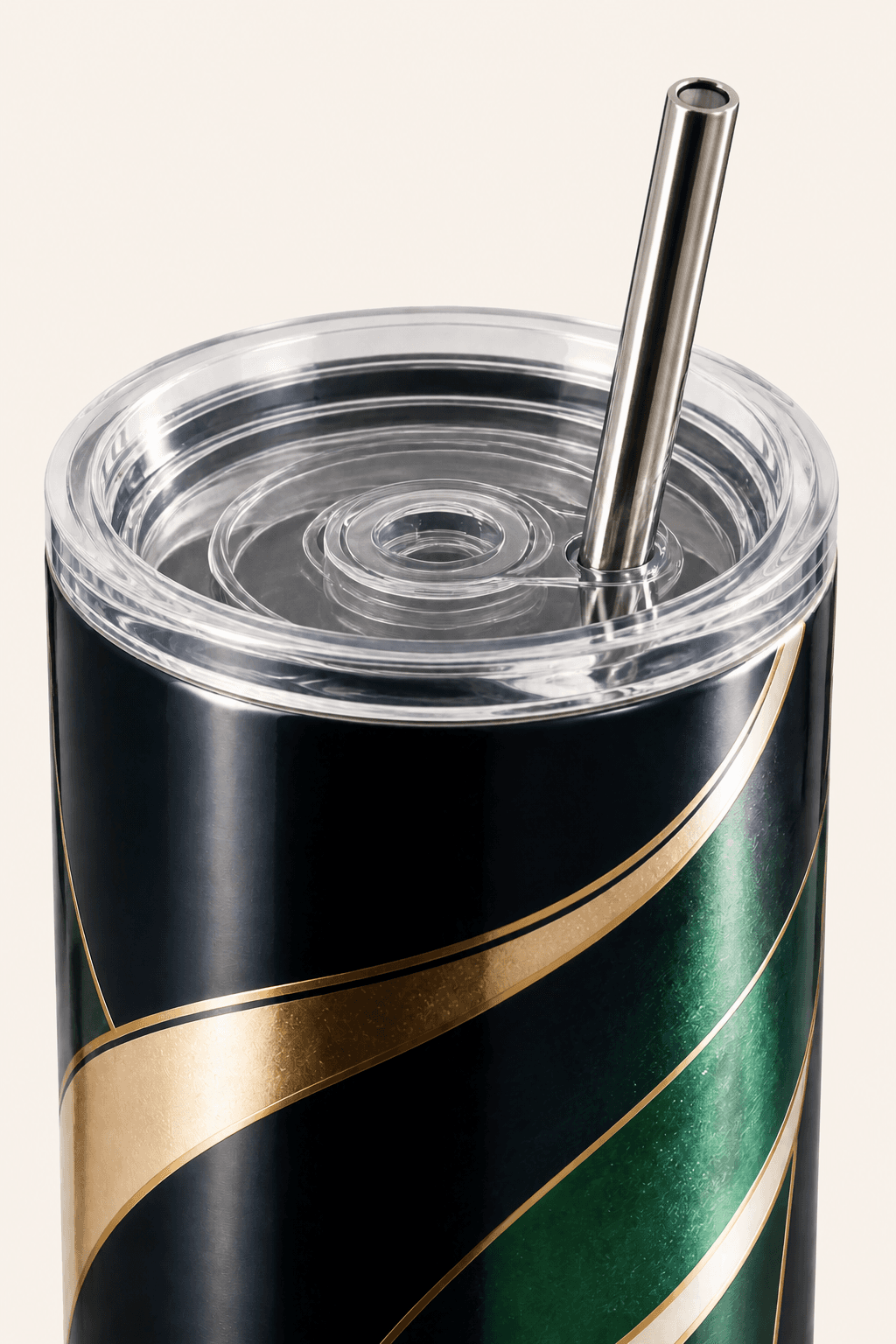 Close view of a custom tumbler’s clear lid, straw, and navy, emerald, ivory, and gold wrap.